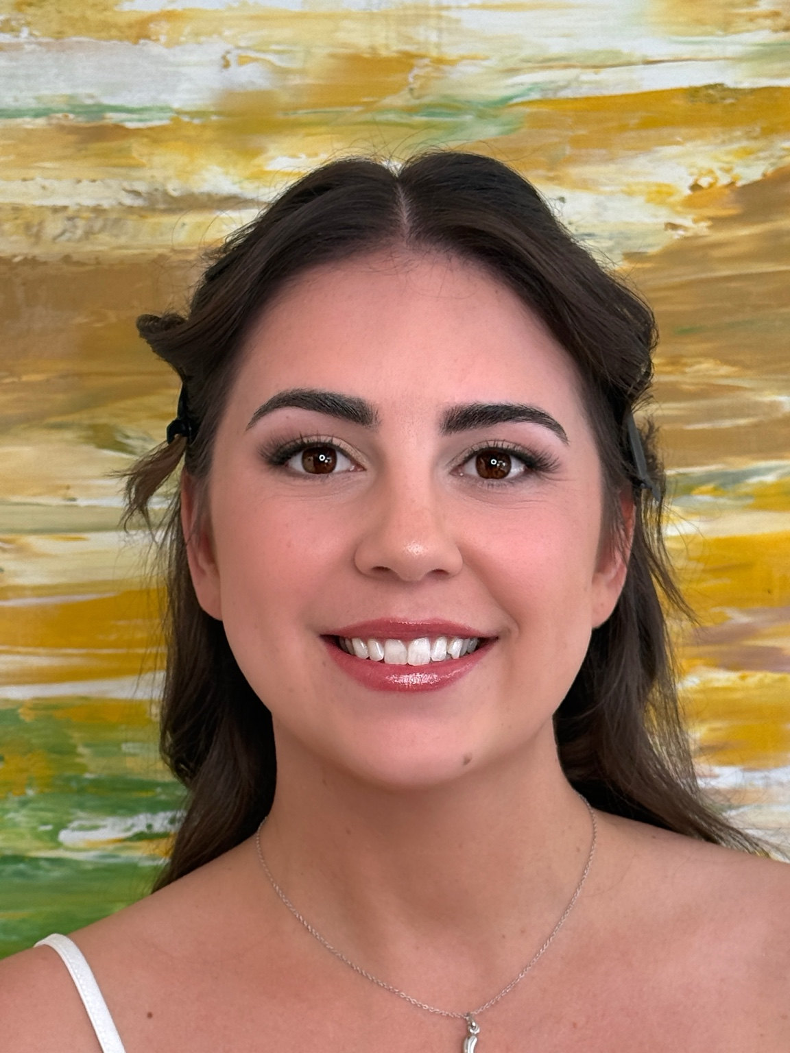 Radiant bridal makeup with sculpted brows, soft brown eyes, and a pink gloss lip