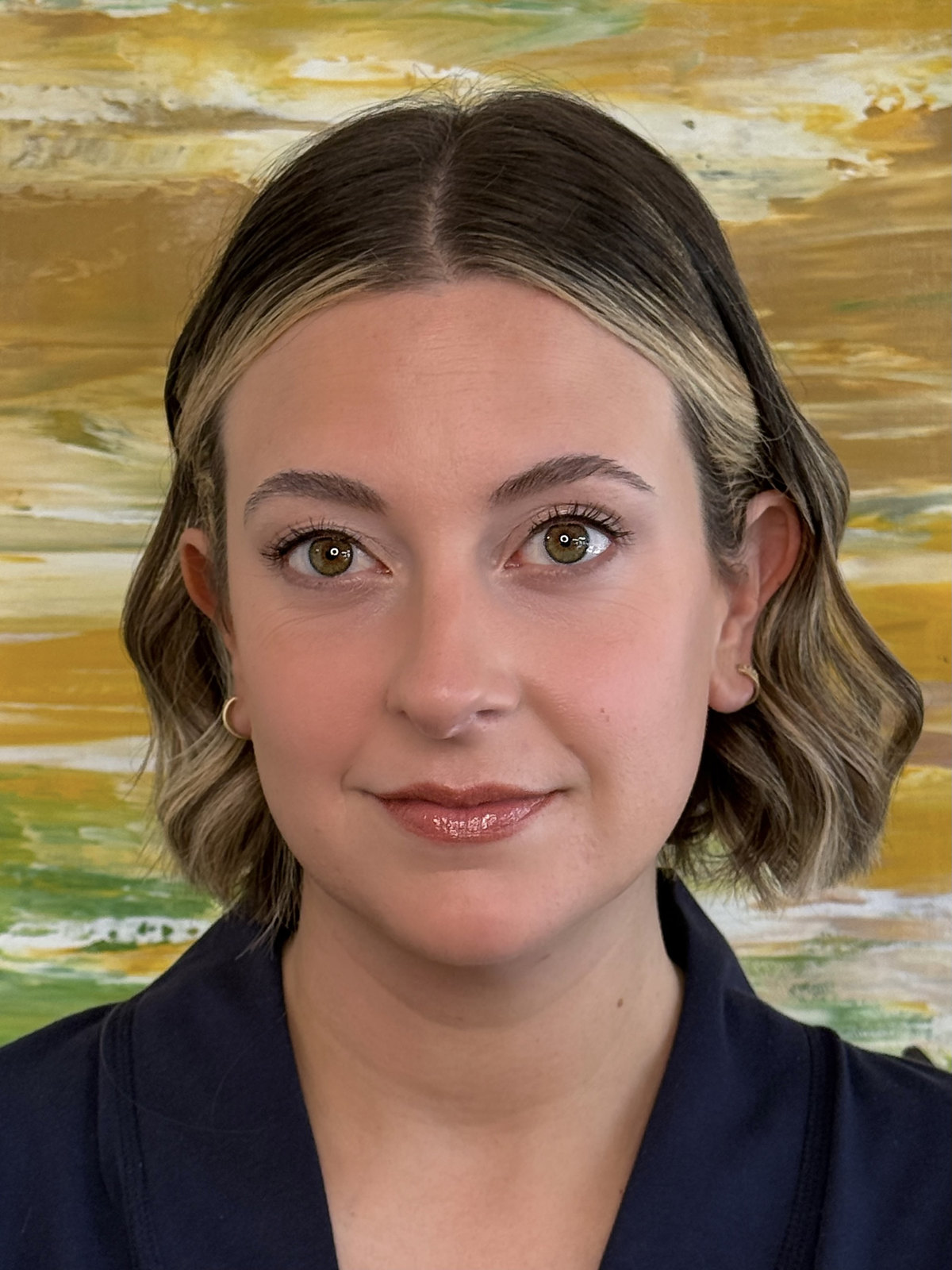 Natural soft glam makeup with defined brows, hazel eyes, and a satin nude-rose lip
