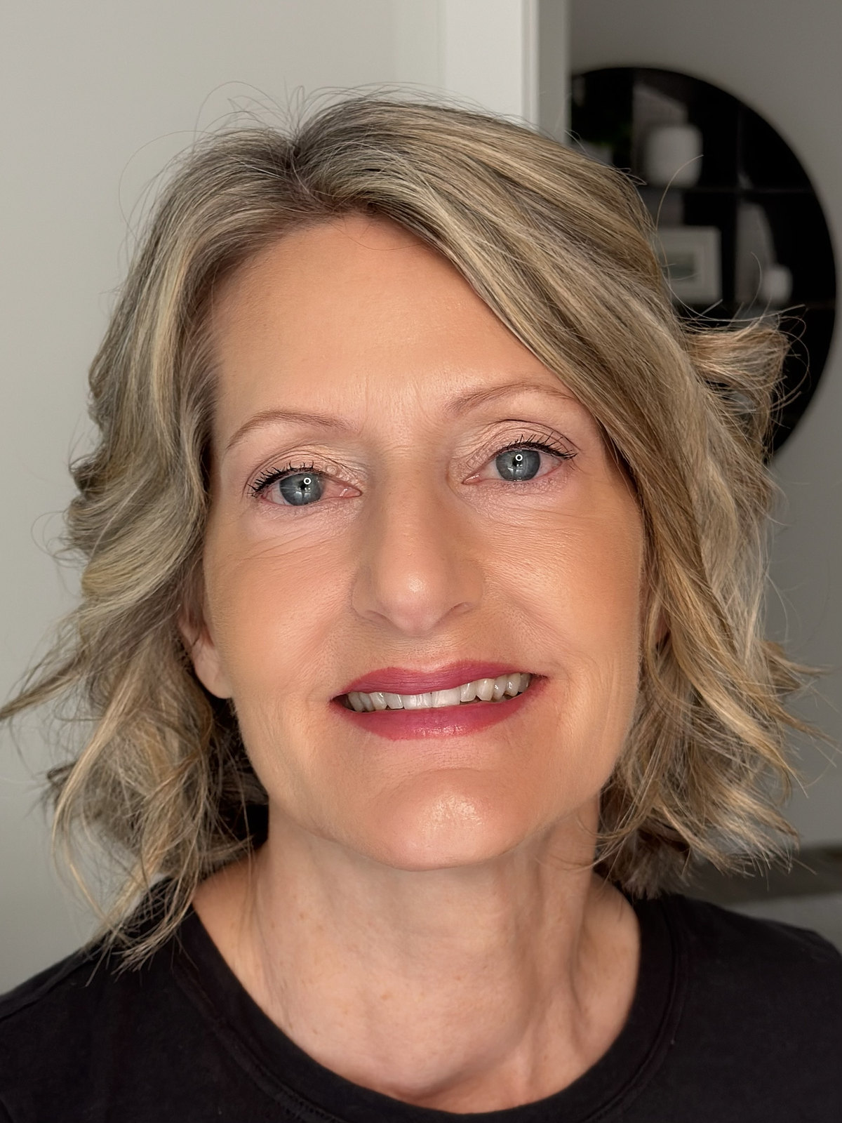 Timeless soft glam with luminous skin, defined blue eyes, and a berry-rose lip